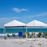 Portable Canopy Shelters with Chairs on the Beach